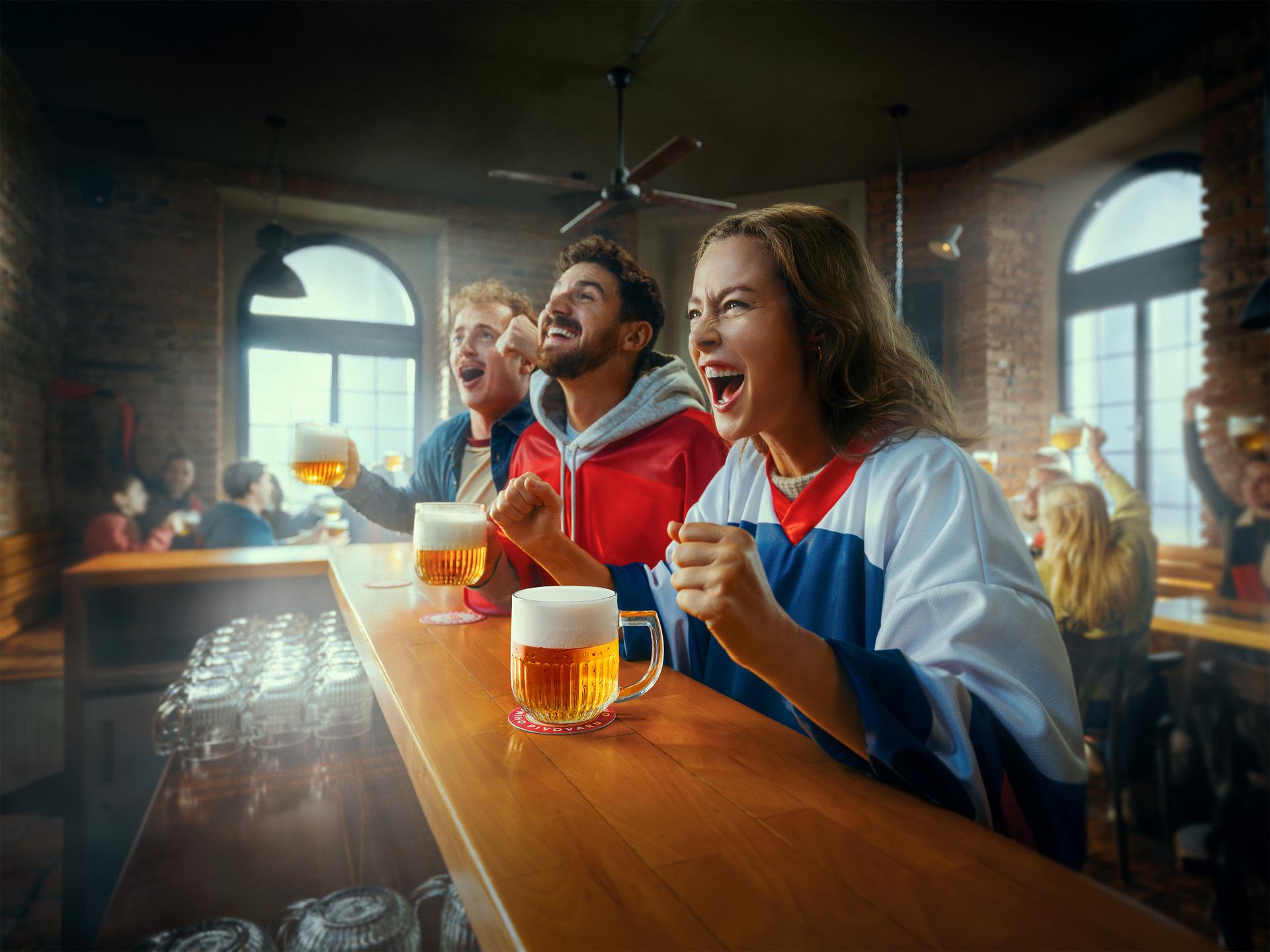Three fans at a bar with beer